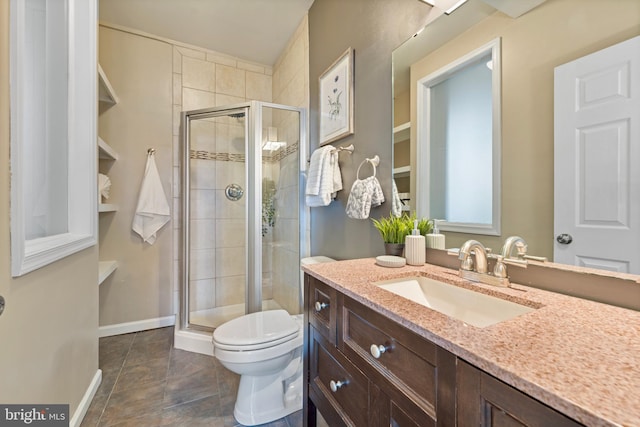 bathroom featuring tile patterned floors, vanity, toilet, and a shower with shower door