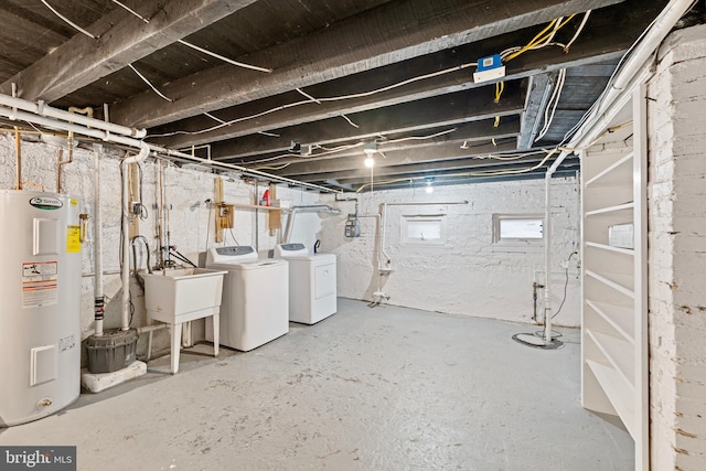 basement with washer and dryer, electric water heater, and sink