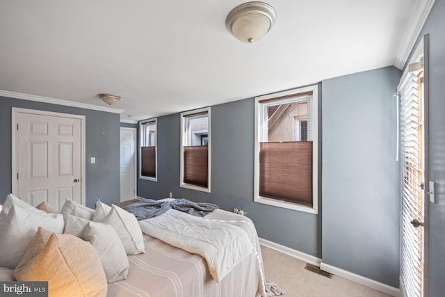 carpeted bedroom with multiple windows and ornamental molding