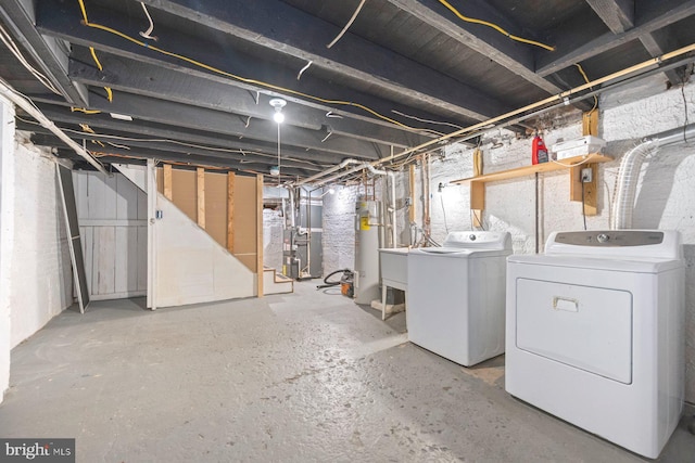 basement with washer and dryer and heating unit