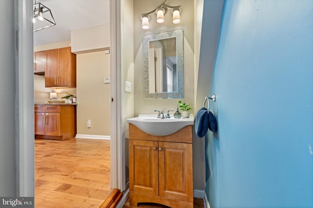 bathroom with vanity and wood-type flooring