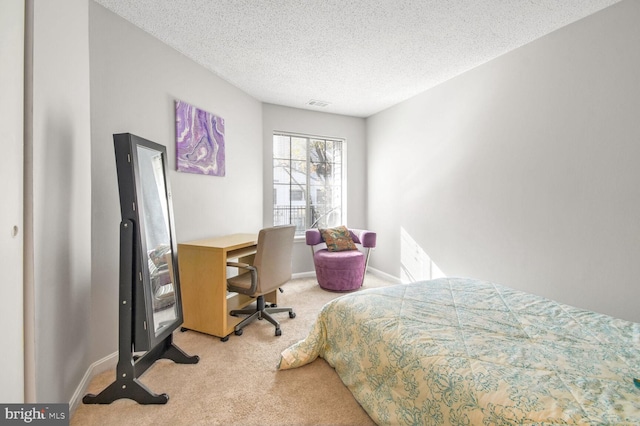 carpeted bedroom with a textured ceiling