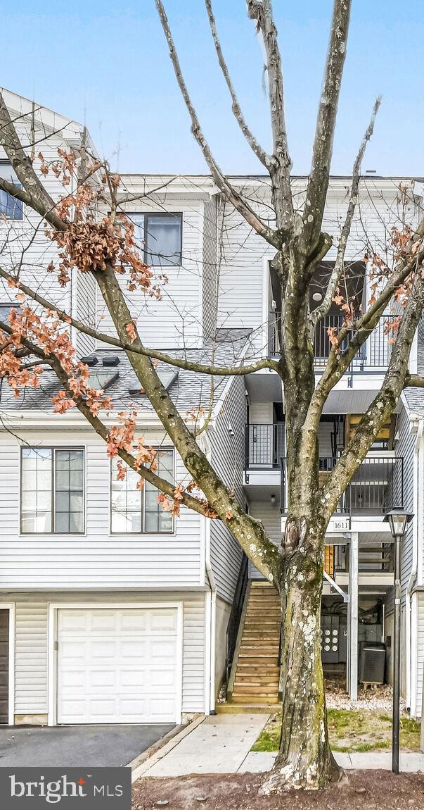 view of property featuring a balcony and a garage