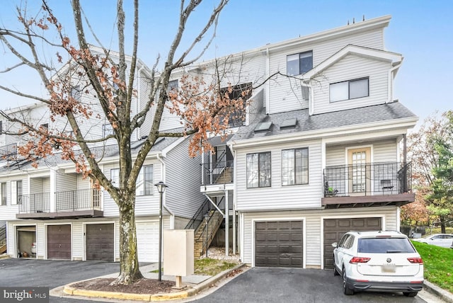 view of property featuring a balcony and a garage