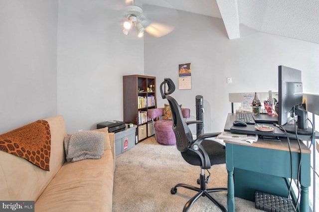 carpeted office space featuring ceiling fan, a textured ceiling, and vaulted ceiling with beams