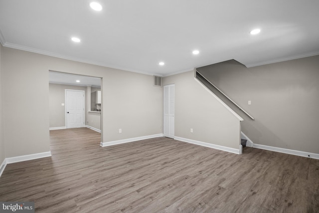 unfurnished living room with hardwood / wood-style flooring and ornamental molding