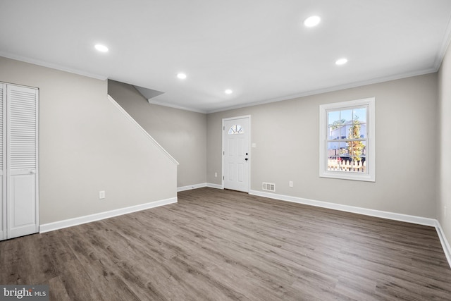 interior space featuring hardwood / wood-style flooring and crown molding