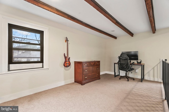 carpeted home office featuring beam ceiling