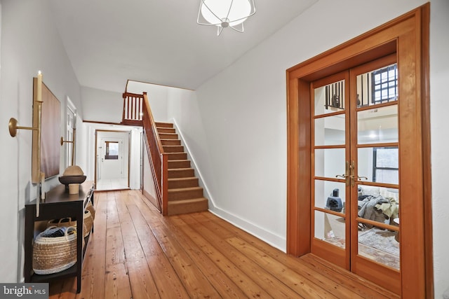 foyer entrance featuring light hardwood / wood-style flooring and french doors