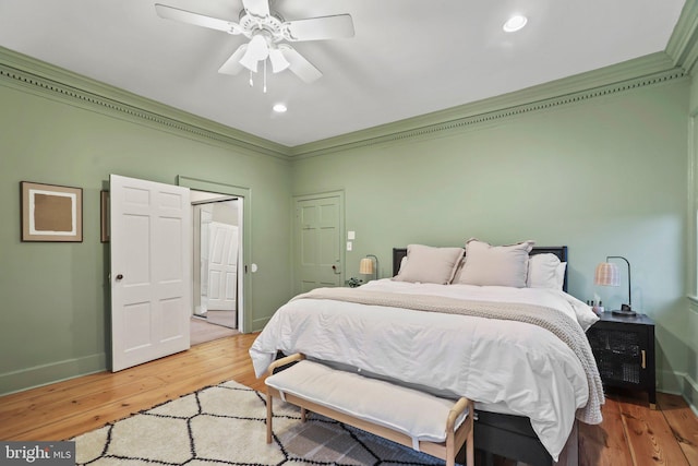 bedroom with hardwood / wood-style flooring, ceiling fan, and crown molding