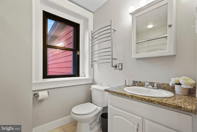 bathroom with toilet, tile patterned floors, radiator, and plenty of natural light