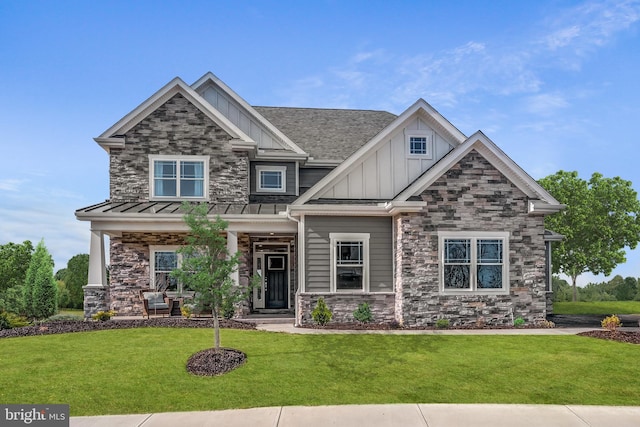 craftsman-style house featuring a front yard and covered porch