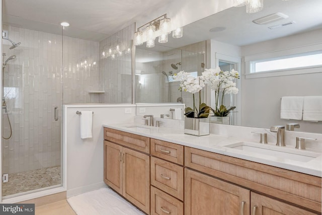 bathroom featuring vanity and a shower with door