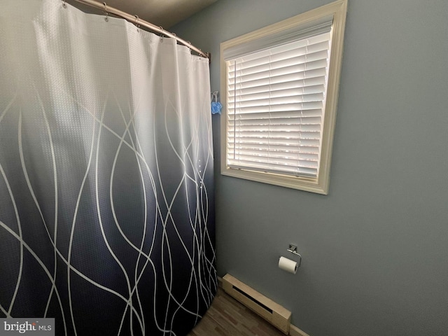 bathroom featuring hardwood / wood-style floors and a baseboard radiator