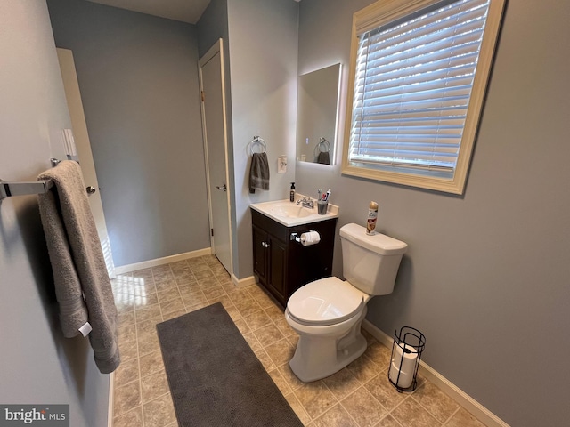 bathroom featuring toilet, vanity, and tile patterned flooring