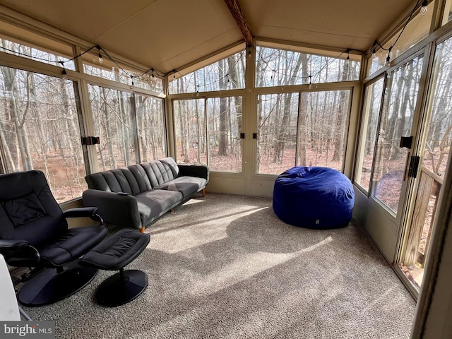 sunroom featuring lofted ceiling with beams