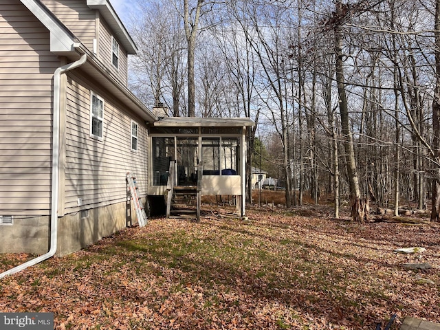 view of yard with a sunroom