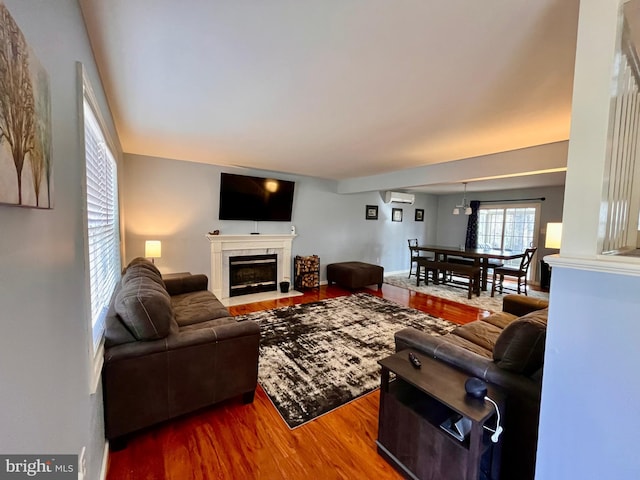 living room featuring a wall unit AC and hardwood / wood-style floors