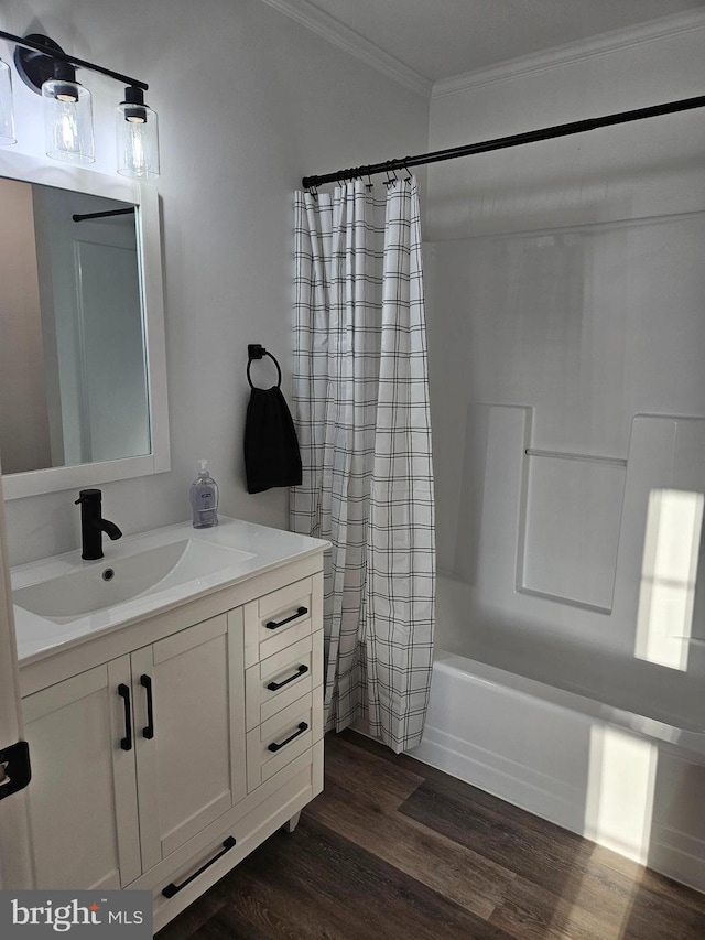 bathroom featuring vanity, shower / bath combo with shower curtain, wood-type flooring, and crown molding