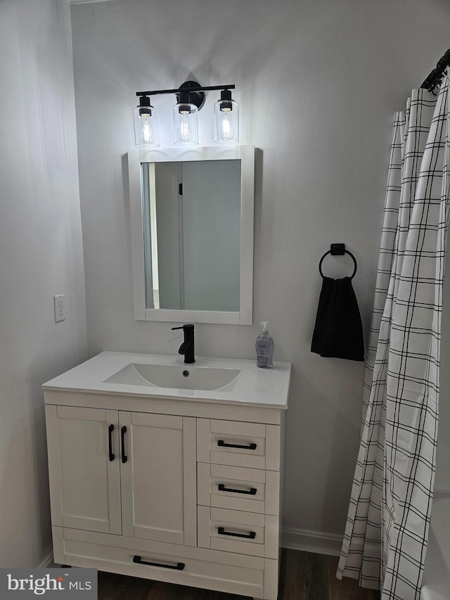 bathroom with hardwood / wood-style flooring and vanity