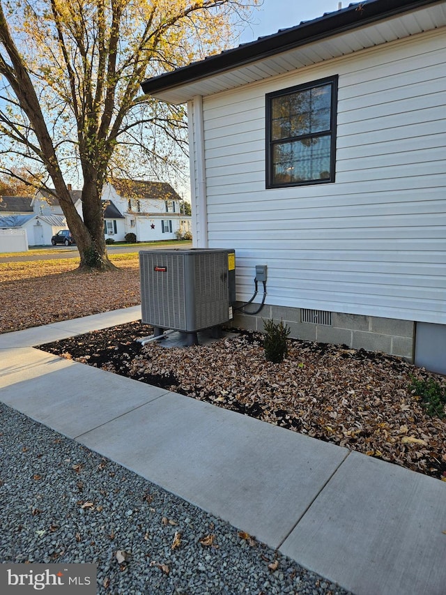 view of side of home with central AC