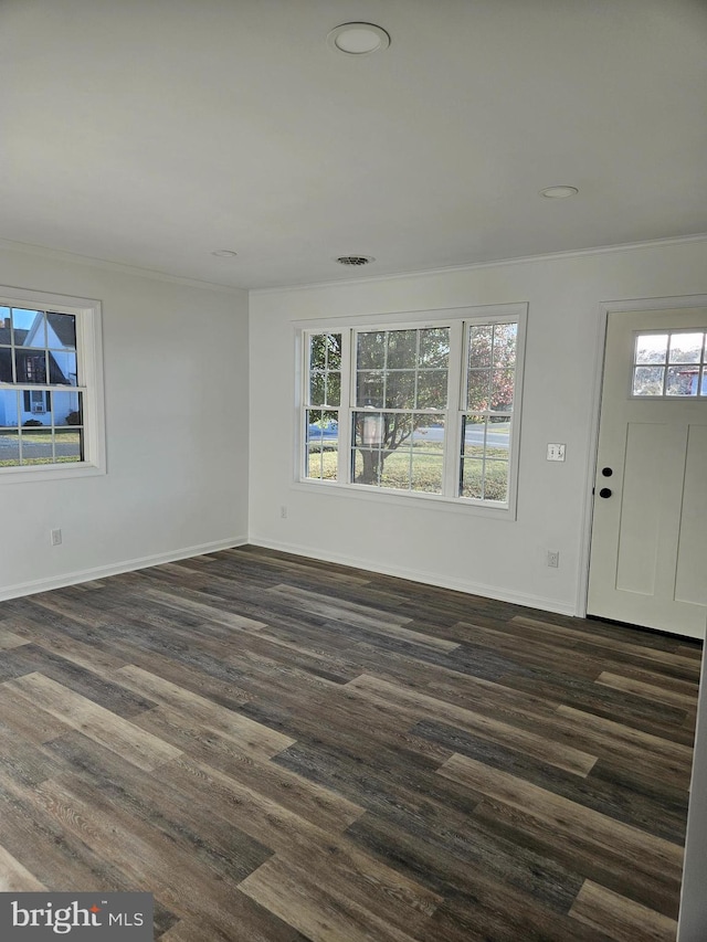 entrance foyer with dark hardwood / wood-style floors and ornamental molding