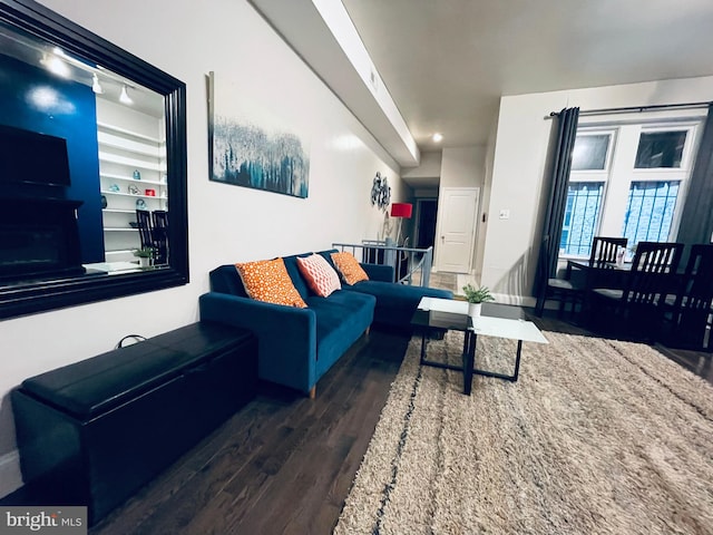 living room featuring dark wood-type flooring