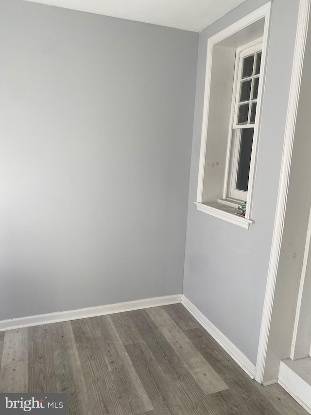 empty room with dark hardwood / wood-style flooring