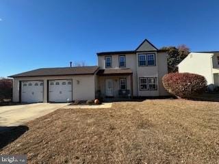 front facade featuring a garage and a front yard