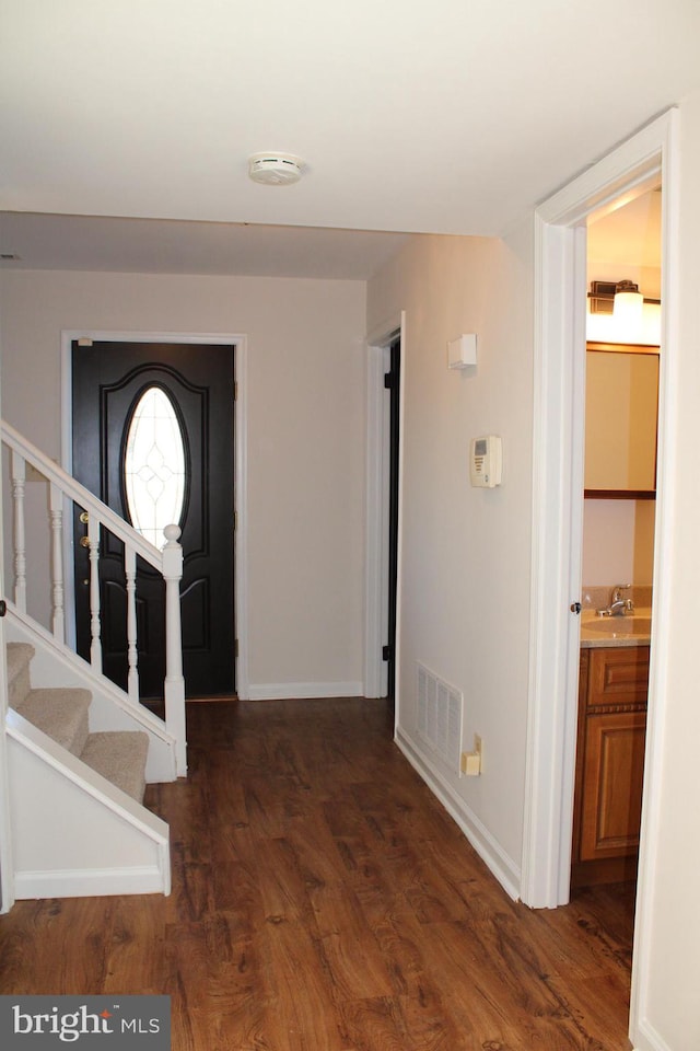 entrance foyer featuring dark hardwood / wood-style flooring