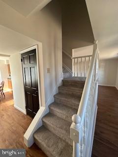 staircase with wood-type flooring