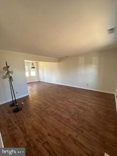 unfurnished living room with dark wood-type flooring