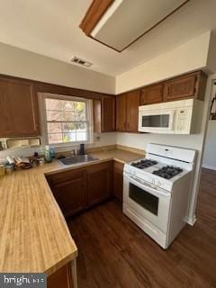 kitchen featuring white appliances, sink, and dark hardwood / wood-style flooring