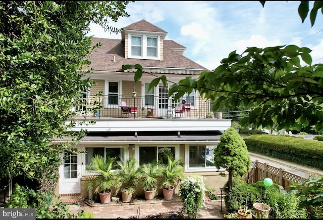 back of property with a balcony