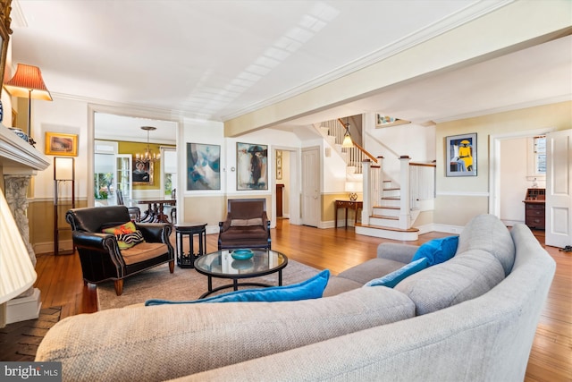 living room featuring crown molding, a chandelier, and hardwood / wood-style floors