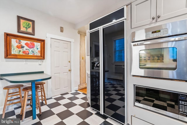 kitchen featuring white cabinetry and appliances with stainless steel finishes