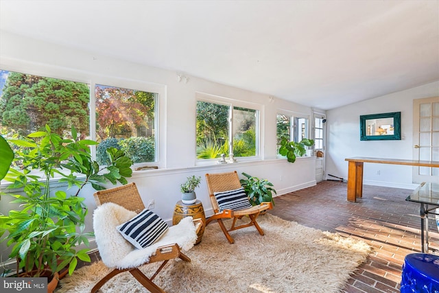 sunroom with lofted ceiling and a wealth of natural light