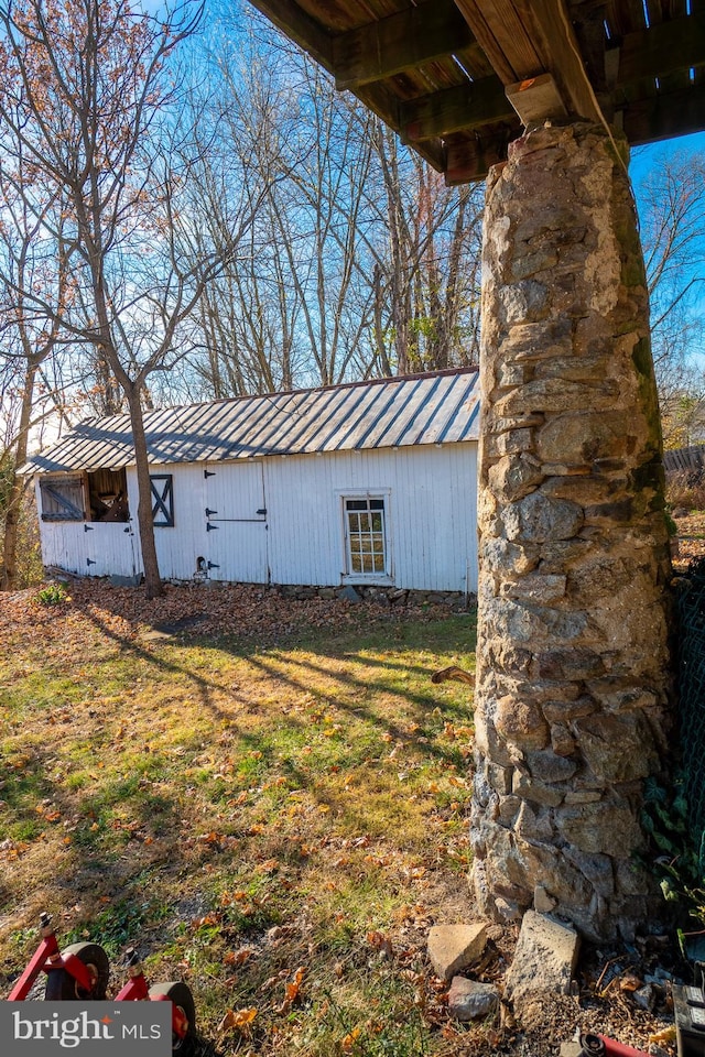 view of outbuilding featuring a yard