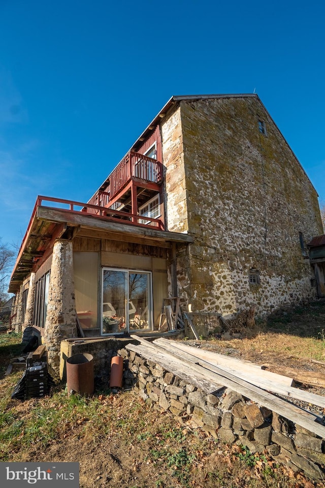 view of side of home with a balcony