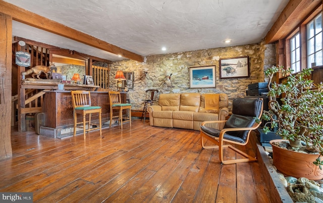 living room with beam ceiling and wood-type flooring