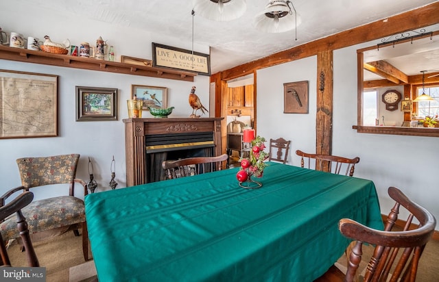 dining area with a fireplace and ceiling fan