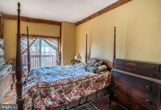 bedroom featuring wood finished floors and access to outside