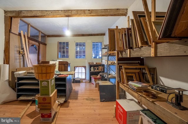 misc room featuring light hardwood / wood-style floors and beam ceiling