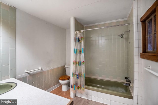 full bathroom featuring hardwood / wood-style floors, vanity, toilet, and shower / bathtub combination with curtain