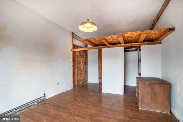 interior space with dark wood-type flooring and a baseboard radiator