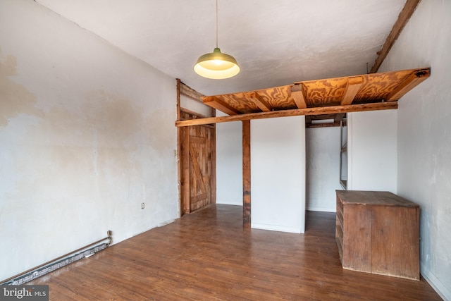 spare room featuring wood finished floors and a baseboard radiator