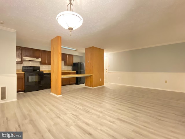 unfurnished living room featuring a textured ceiling, ornamental molding, and light hardwood / wood-style flooring