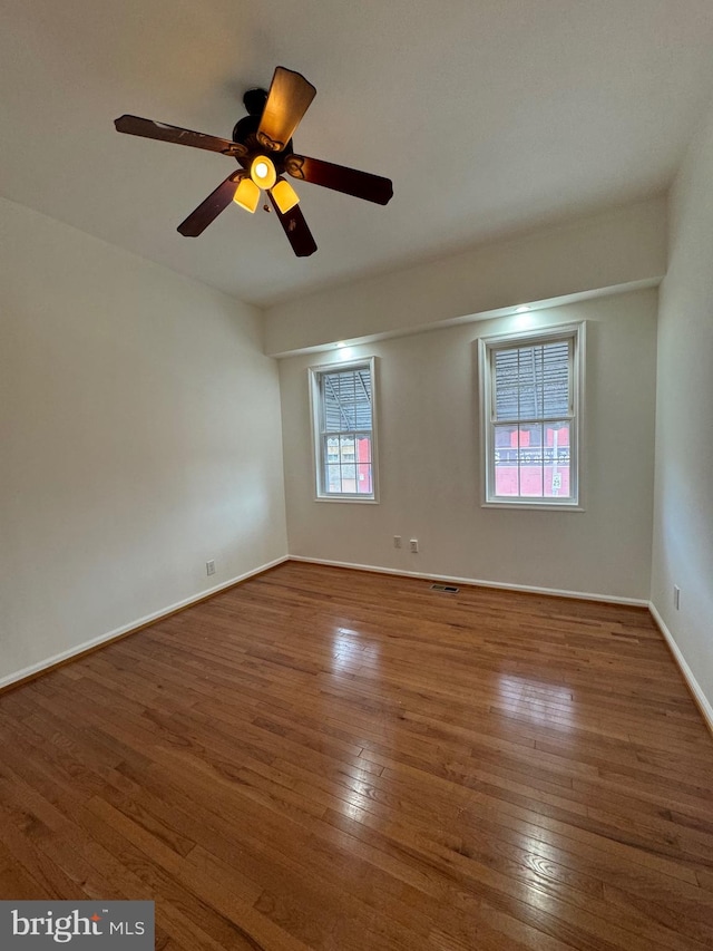 empty room featuring ceiling fan and wood-type flooring