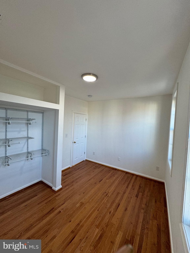 unfurnished bedroom featuring hardwood / wood-style flooring and a closet