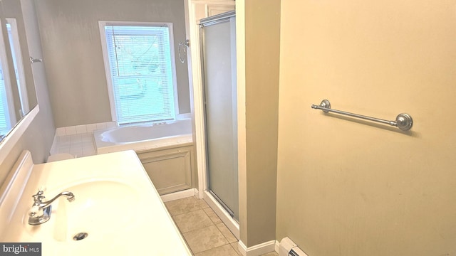 bathroom featuring tile patterned flooring, separate shower and tub, and sink